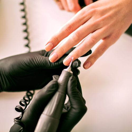 Close up image of woman making hardware manicure, nail service industry, fashion salon details, master of manicure.